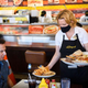 server bringing food to customers in restaurant